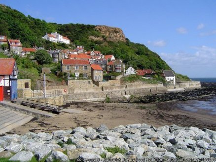 Runswick Bay Sheltered from the north winds by Lingrow Knowle, the quaint village of Runswick Bay with its white painted cottages and neat gardens looks out on one of the loveliest bays in the north of England.